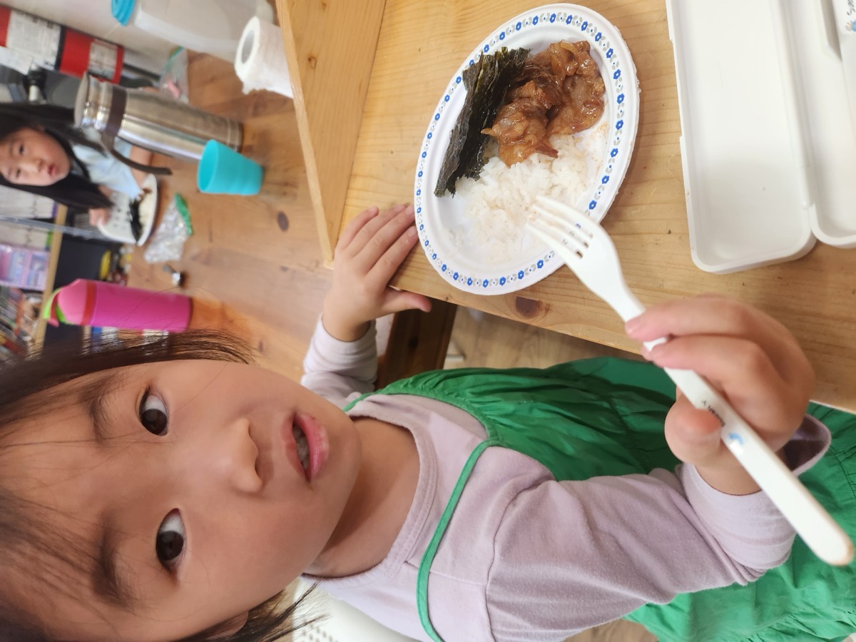 A girl eating lunch with a fork