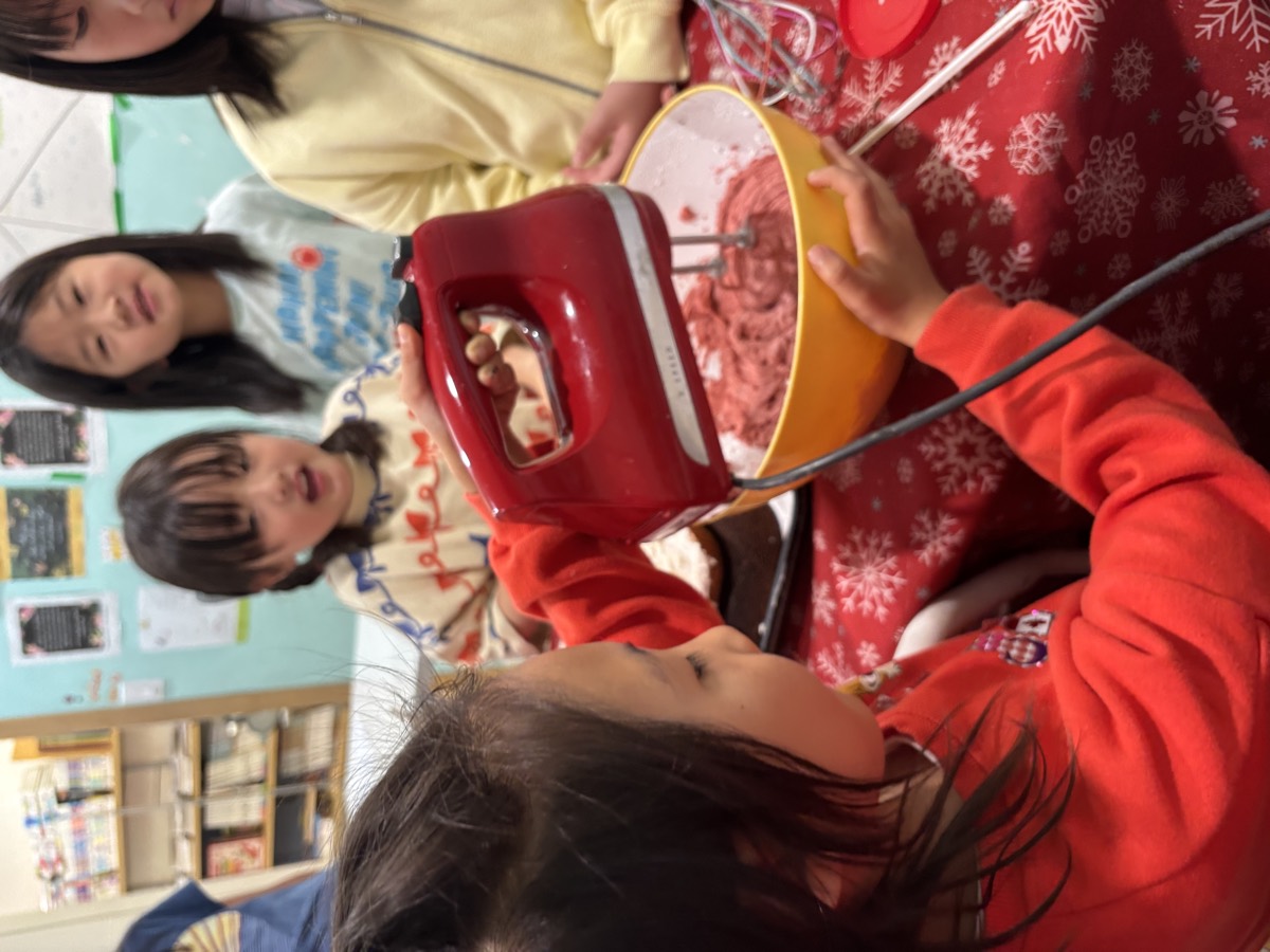 A girl lifting the mixer as friends watch