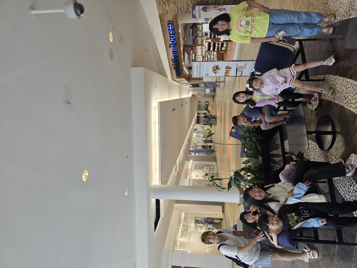 The group resting together on a bench at the mall