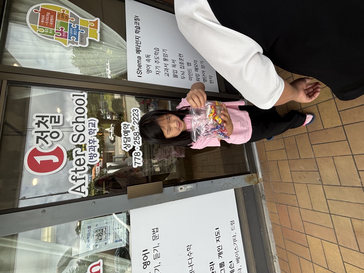 A girl holding her bag of candy prizes