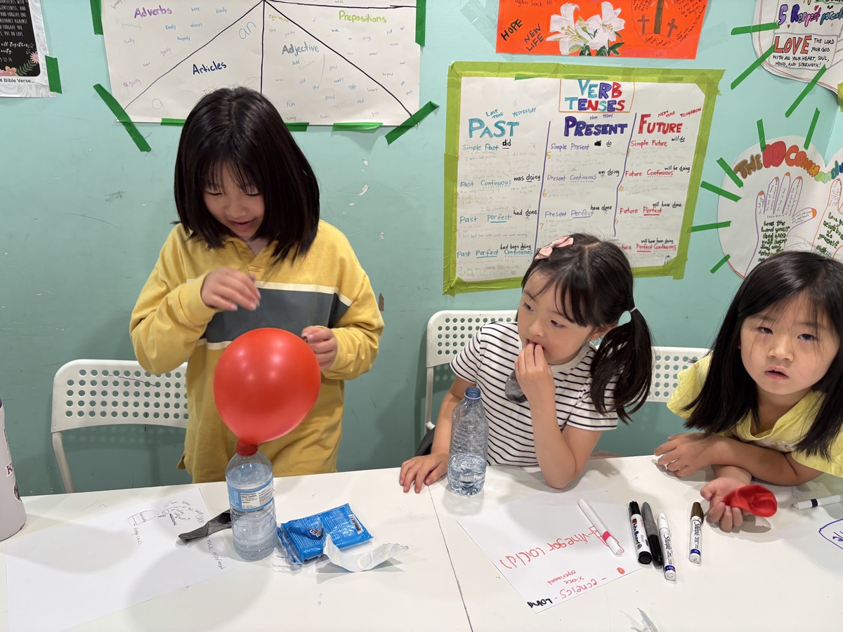 Children doing the balloon science experiment together