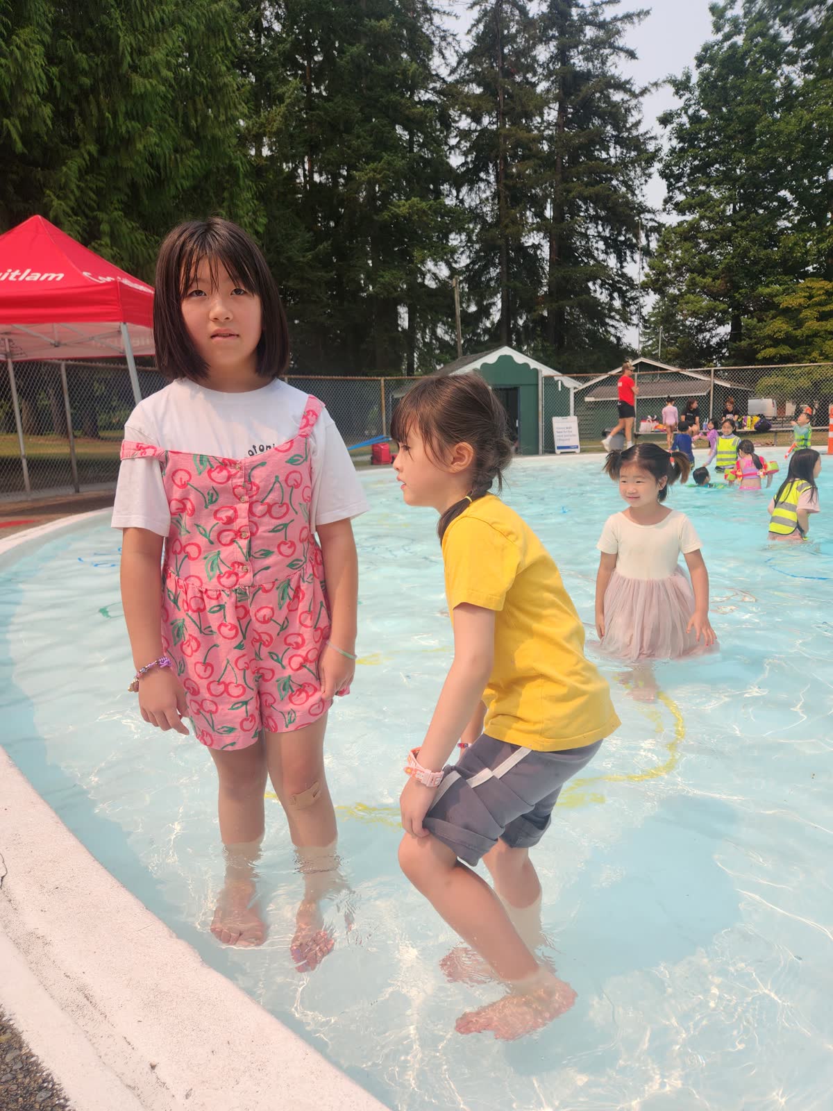 Children enjoying supervised water play in the pool