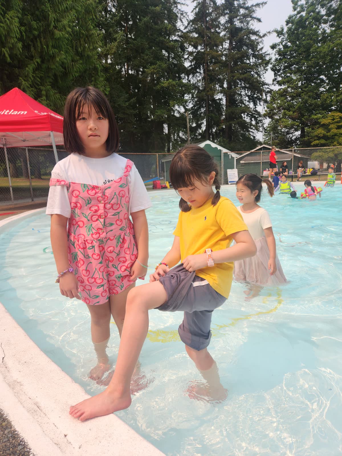 Young campers playing together in an outdoor pool