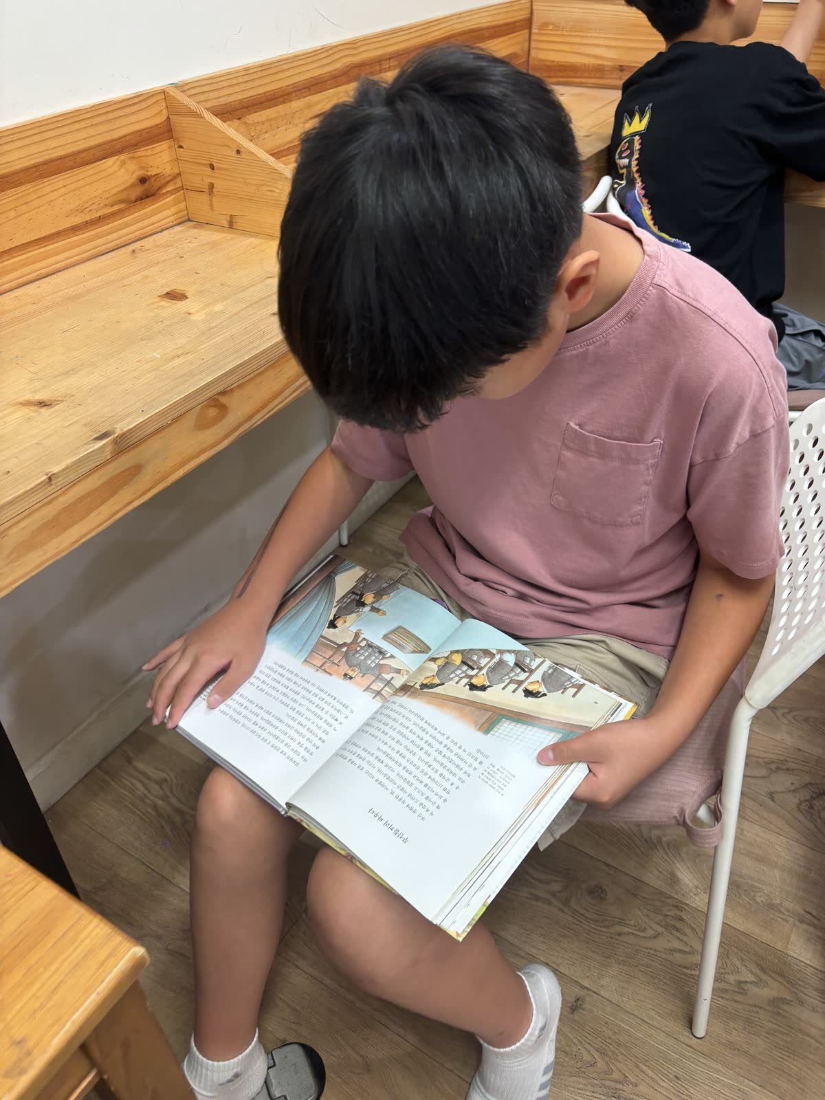 A student enjoying a book during quiet reading time