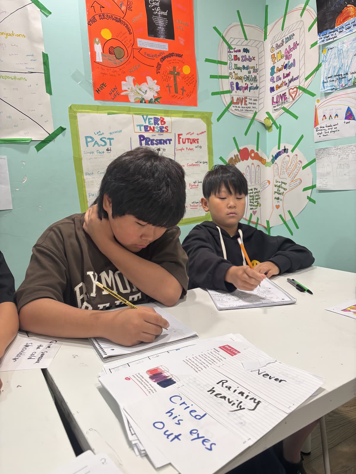 Students developing handwritten pages for their branching stories