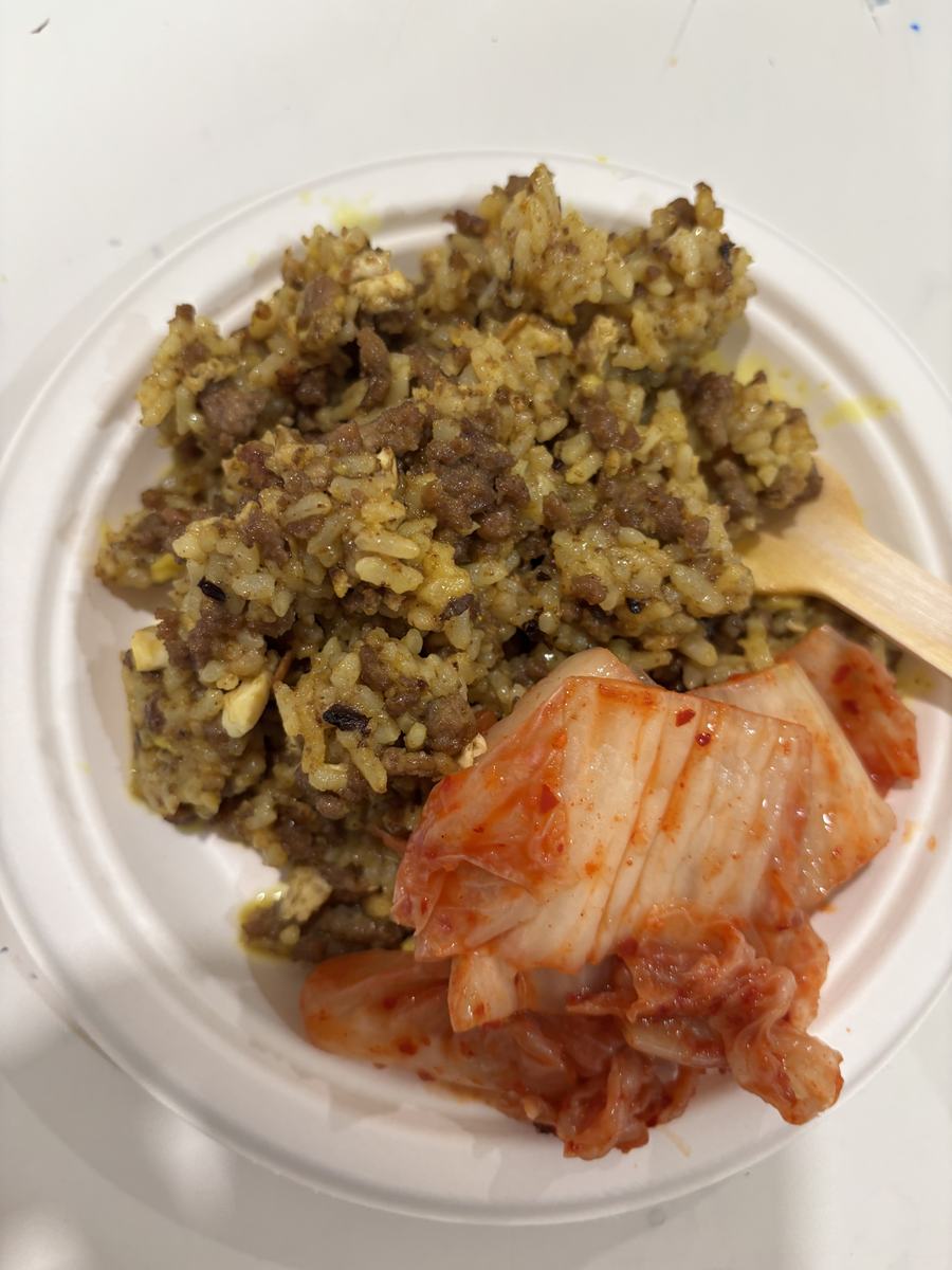 A plate of fried rice served with kimchi