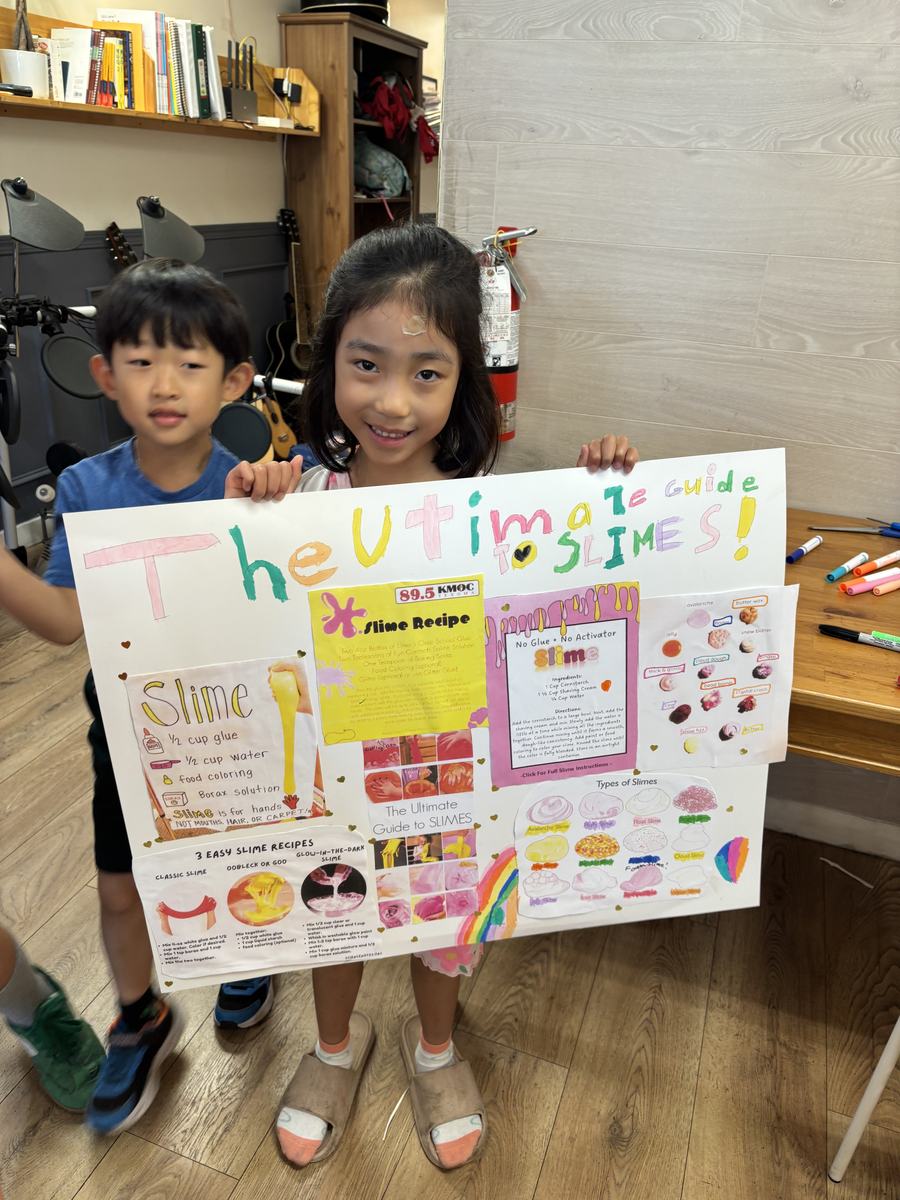 Two students presenting the slime guide poster together