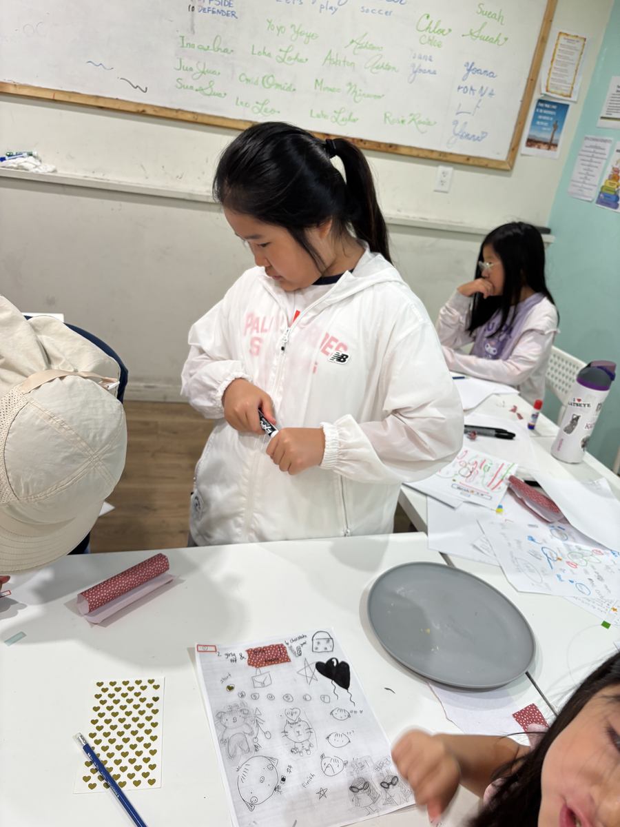 Students working at the table on their sheets