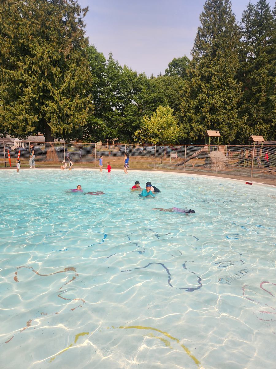Students floating and playing in the shallow end