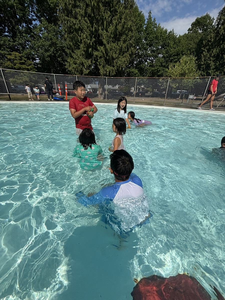 Children playing in the clear shallow outdoor pool