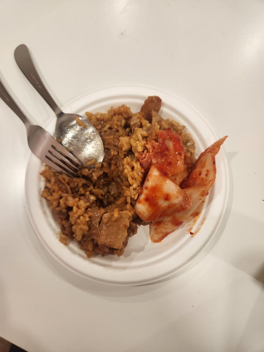 A plate of kimchi fried rice served with kimchi on the side