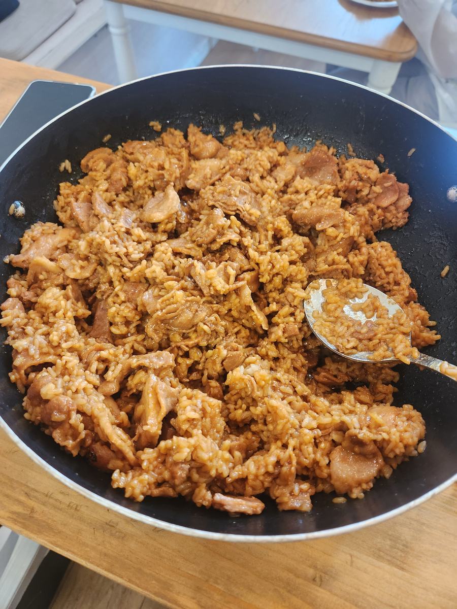 A large pan of kimchi fried rice with pork