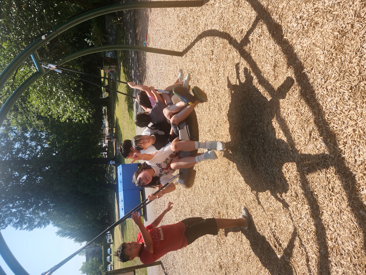 The basket swing in motion with children holding on and laughing