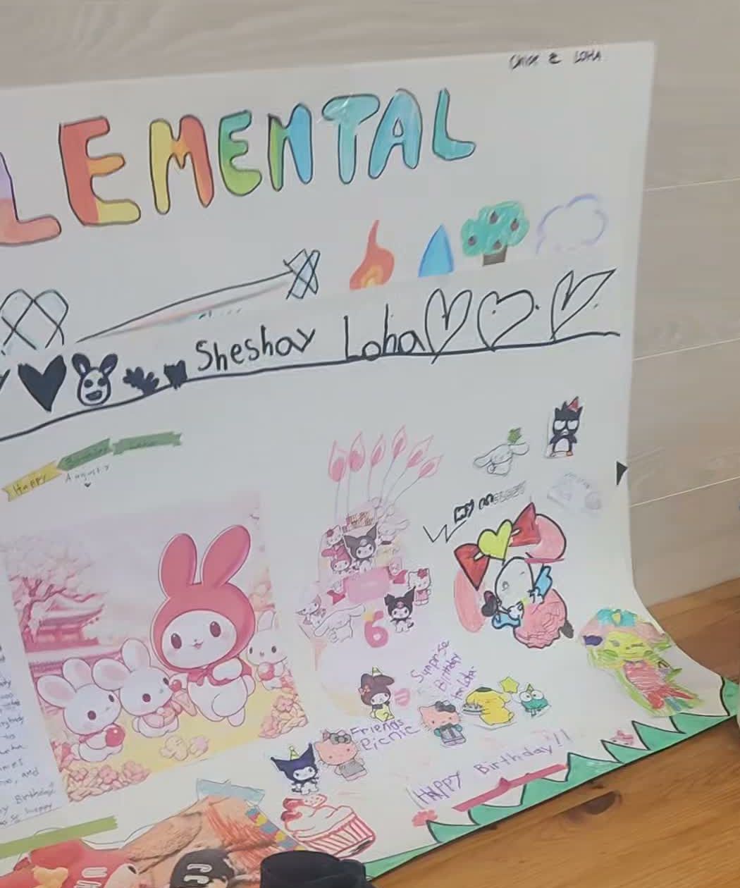 A large handmade birthday poster with Elemental written in coloured bubble letters, covered in stickers, drawings and a Happy Birthday message