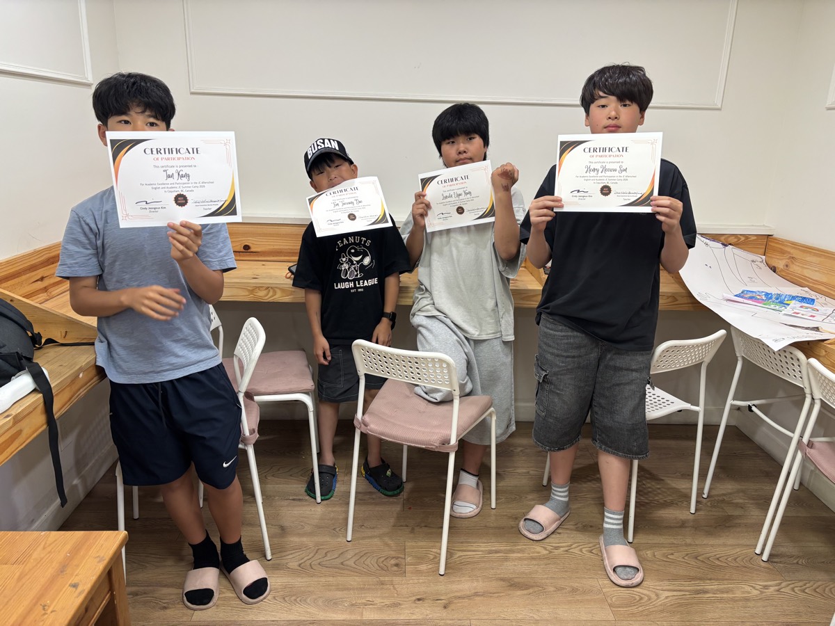 Four senior students standing side by side holding up their certificates of participation