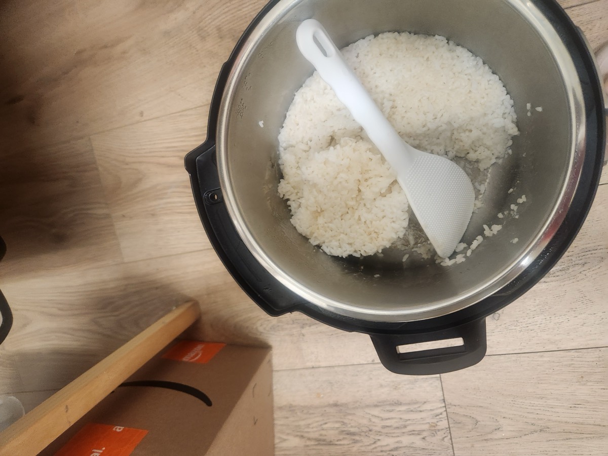 A rice cooker full of freshly cooked white rice