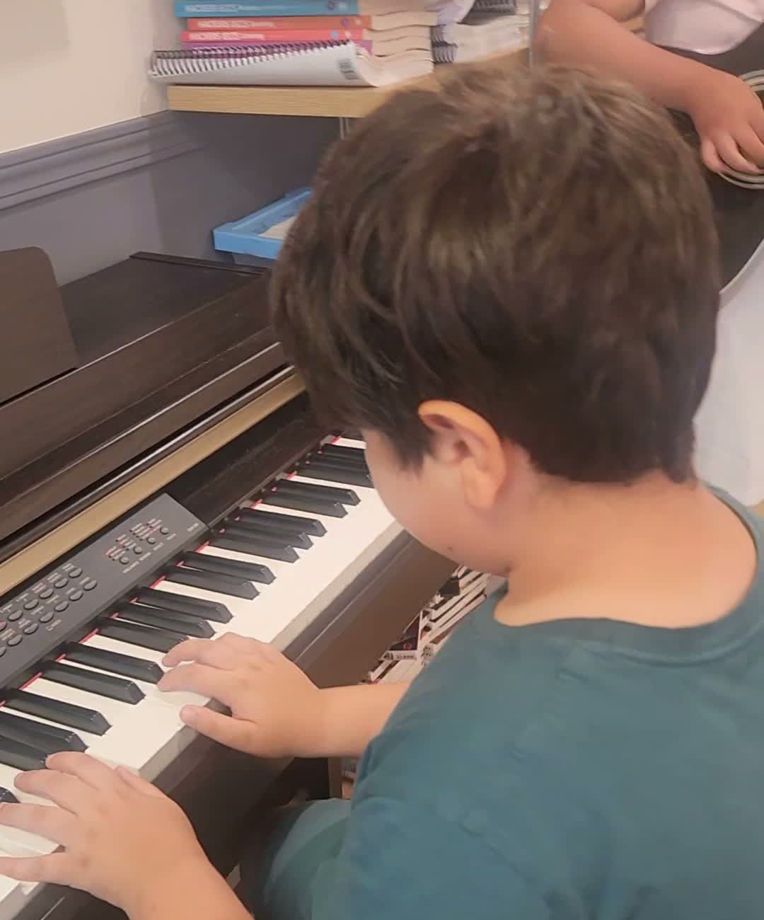 A student playing the classroom piano