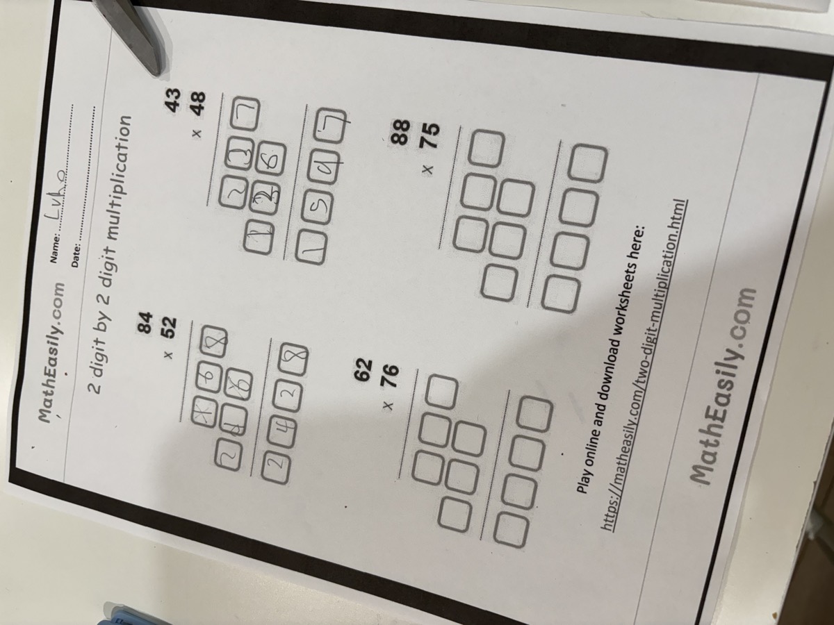 A two-digit by two-digit multiplication worksheet with boxes for working out each step