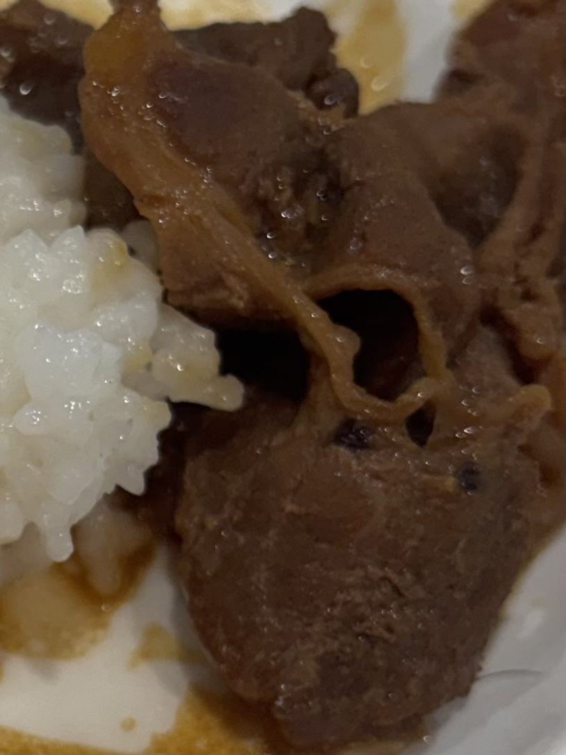 A plate of rice topped with braised beef