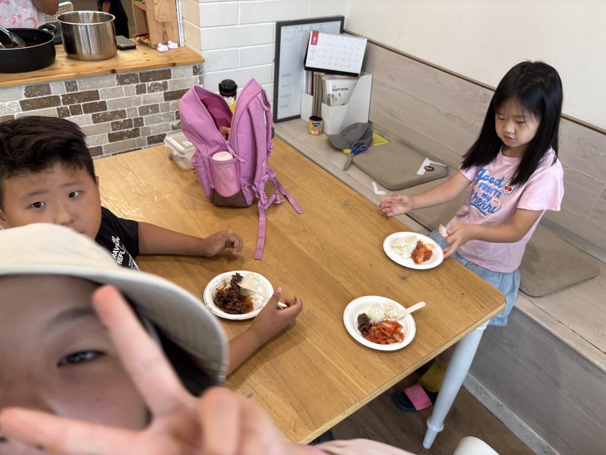 Students sitting around the table with their lunch plates