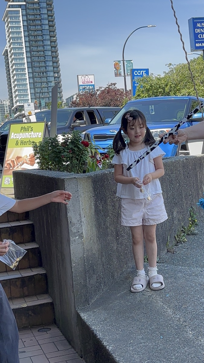 A young girl holding the fishing rod waiting for her candy catch
