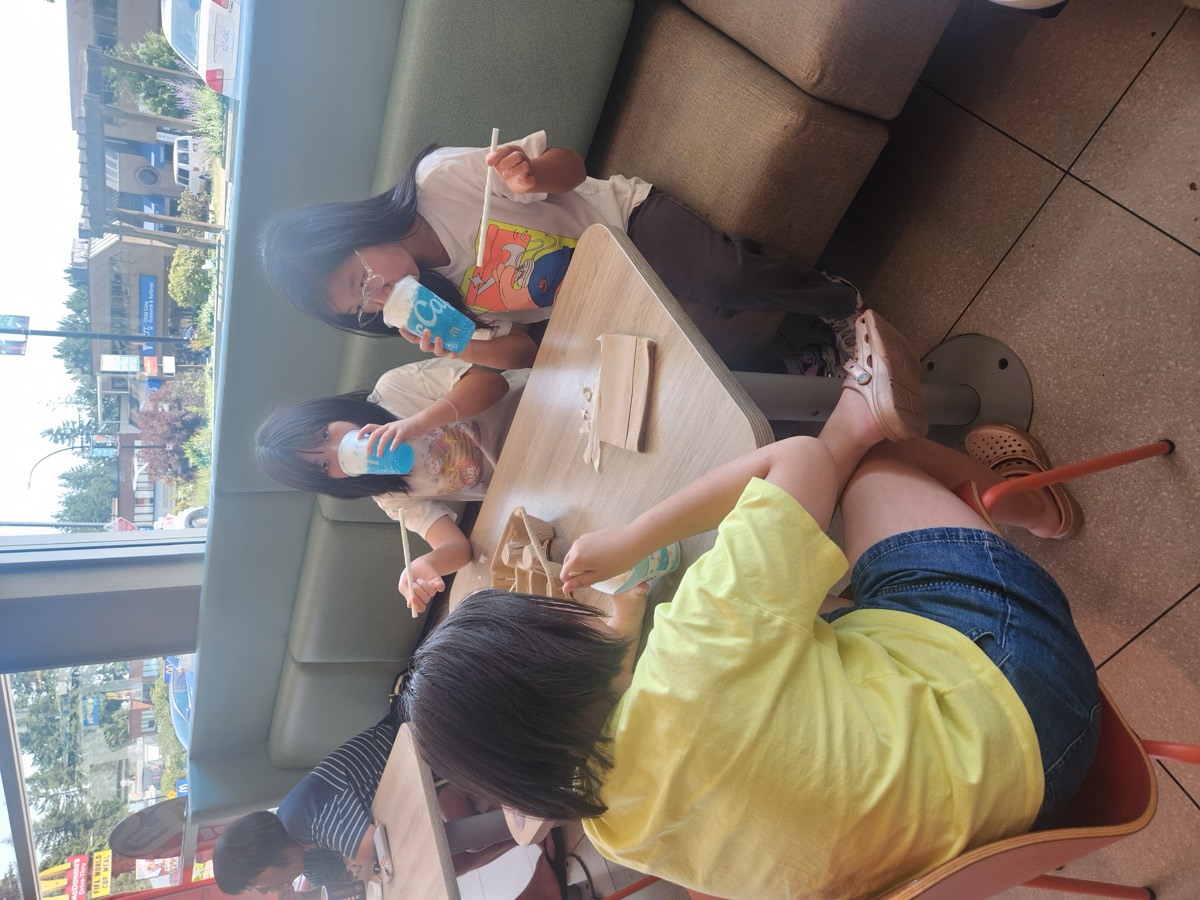 Children enjoying icy blue drinks together at McDonald's