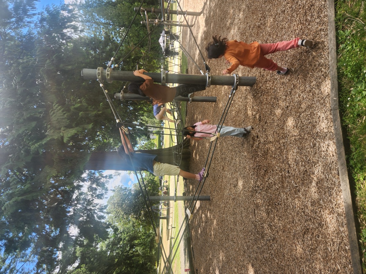 Kids climbing the rope structure at the park playground