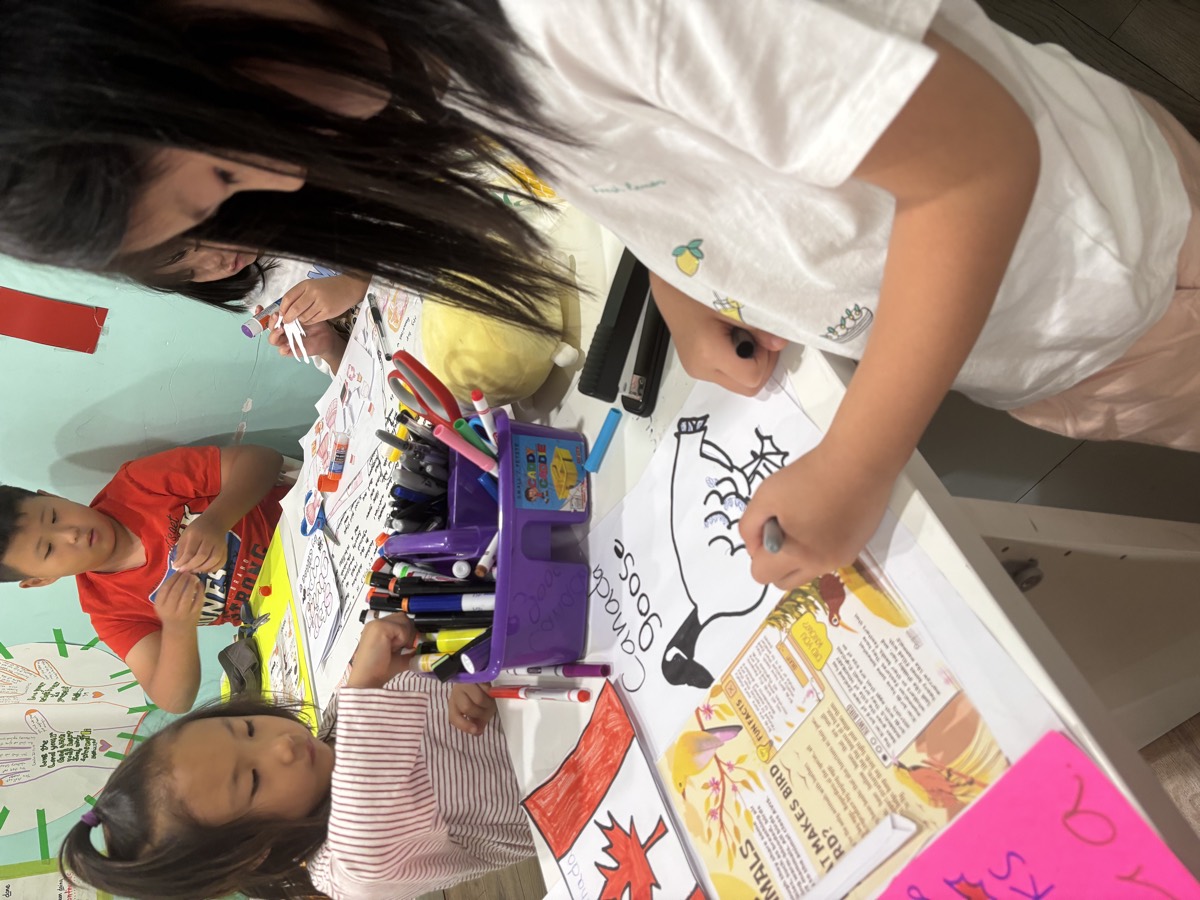 Kids around the table coloring the Canada Goose research poster