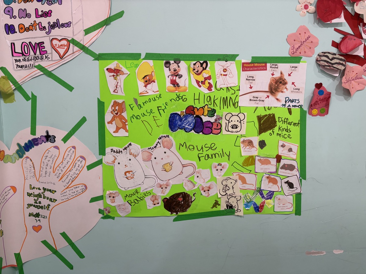 The finished Mouse Family poster taped up on the wall