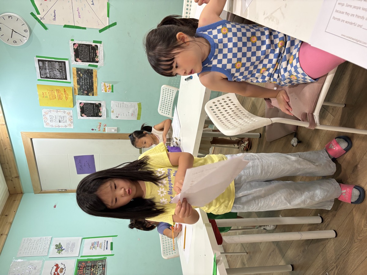 Sua handing a bird worksheet to a seated student
