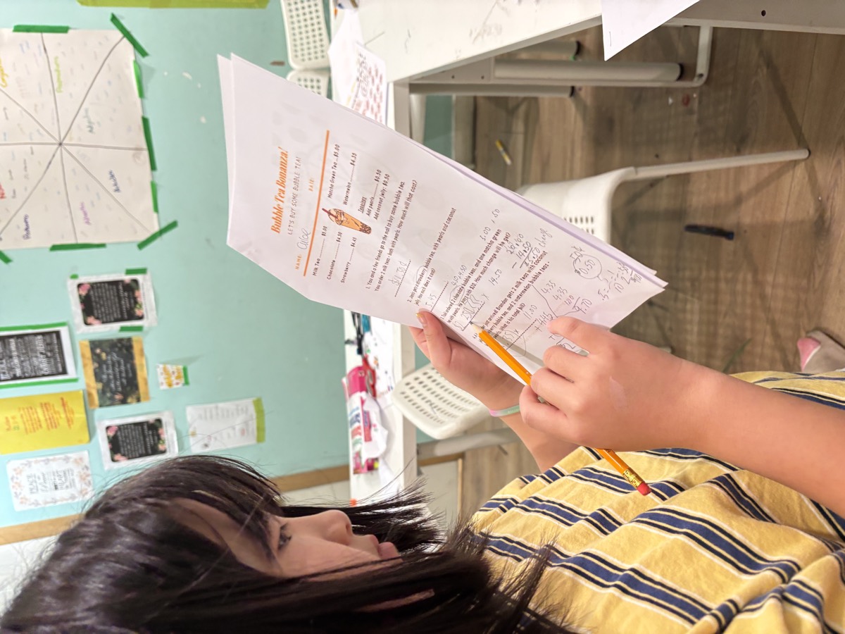 A student reading her Bubble Tea booklet worksheet