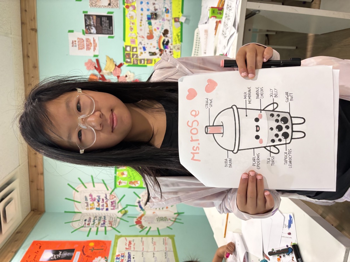 Teacher holding up her Ms. Rose bubble tea character drawing