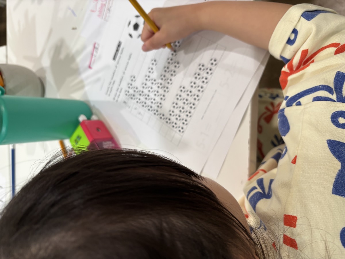 A student working through a worksheet at the table