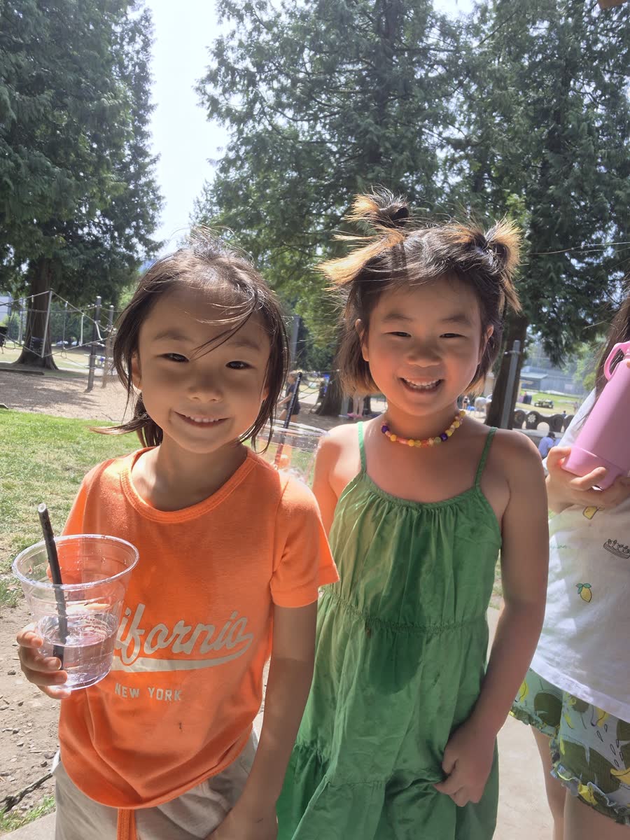 Two friends smiling together at the park