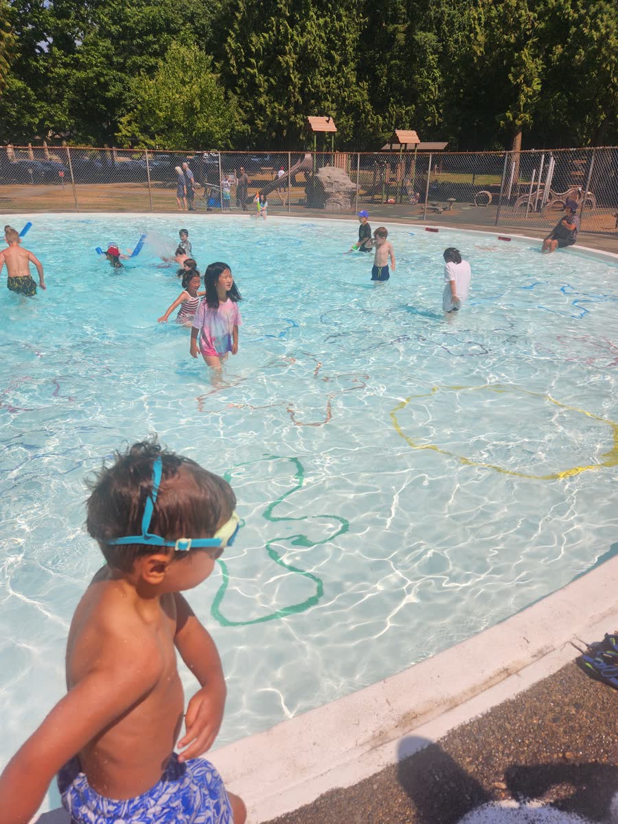 Children playing together in a bright outdoor wading pool