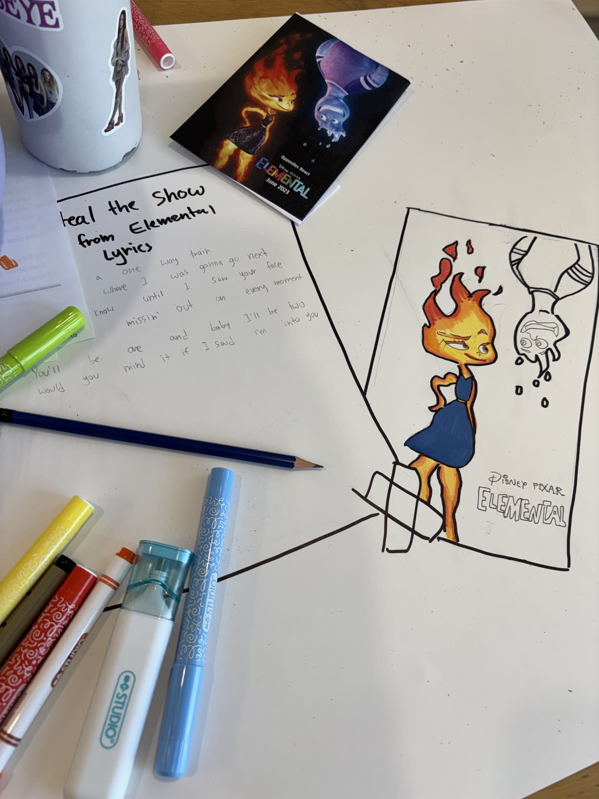 Handwritten lyrics and an illustrated Elemental poster in progress