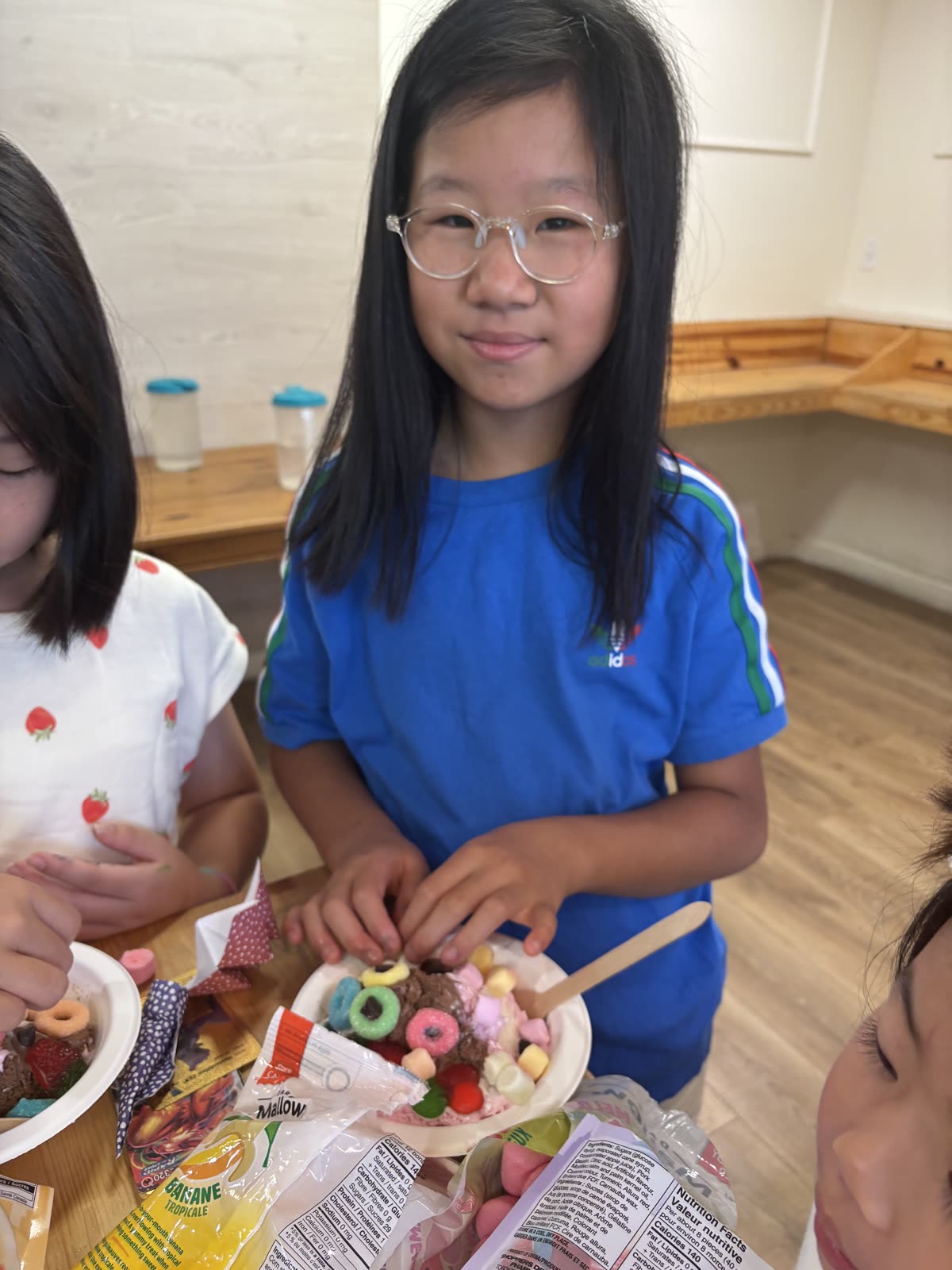 Students adding colorful toppings to an ice-cream sundae