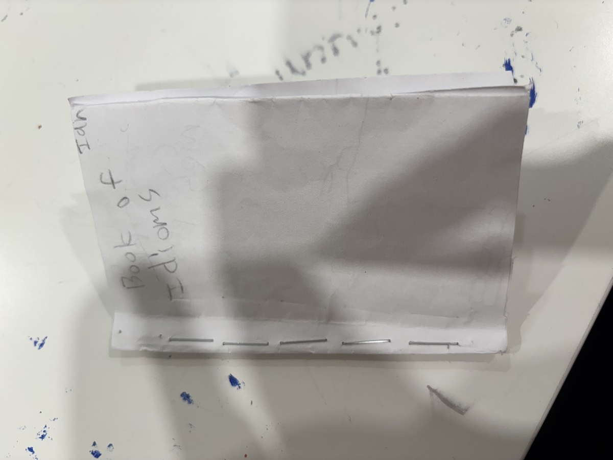A stapled handmade booklet cover reading Ian, Book of Idioms